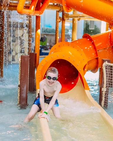 Kid on water slide at family water park